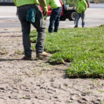 A group of people in yellow shirts and green vests.