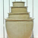 A group of five pots sitting on top of each other.
